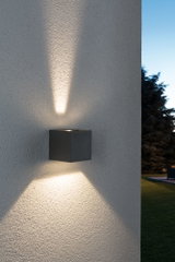Black square outdoor wall light in metal with warm white up and down lighting effect.