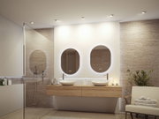Modernes Badezimmer mit Holzwaschtisch, zwei weißen Aufsatzbecken und beleuchteten ovalen Spiegeln