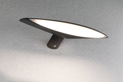 Black metal LED wall light with wide flat light panel for modern indoor lighting solutions