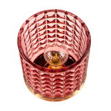 Red glass table lamp with faceted pattern and visible bulb for decorative lighting