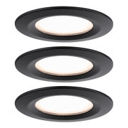Three round matte black LED recessed lights with warm white light for modern room lighting