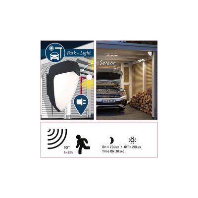Black outdoor wall light with motion sensor and detector for garage and parking area illumination.