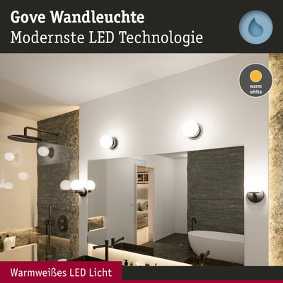 Gove Wandleuchte mit warmweißem LED-Licht in modernem Badezimmer mit Spiegel und Badewanne