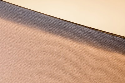 Close-up of beige fabric lampshade with grey edge for modern LED lighting fixtures