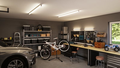 Modern workshop with LED ceiling lights and workbench lighting in grey and wood tones.