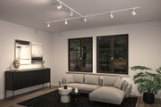 Modern living room with grey fabric sofa, black sideboard and white ceiling spotlights for accent lighting