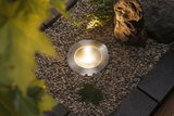 Brushed stainless steel ground spotlight with warm white LED light in gravel for garden lighting