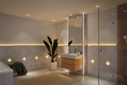 Modern bathroom with grey tiles, wooden vanity unit and warm white LED mirror lighting for ambient light