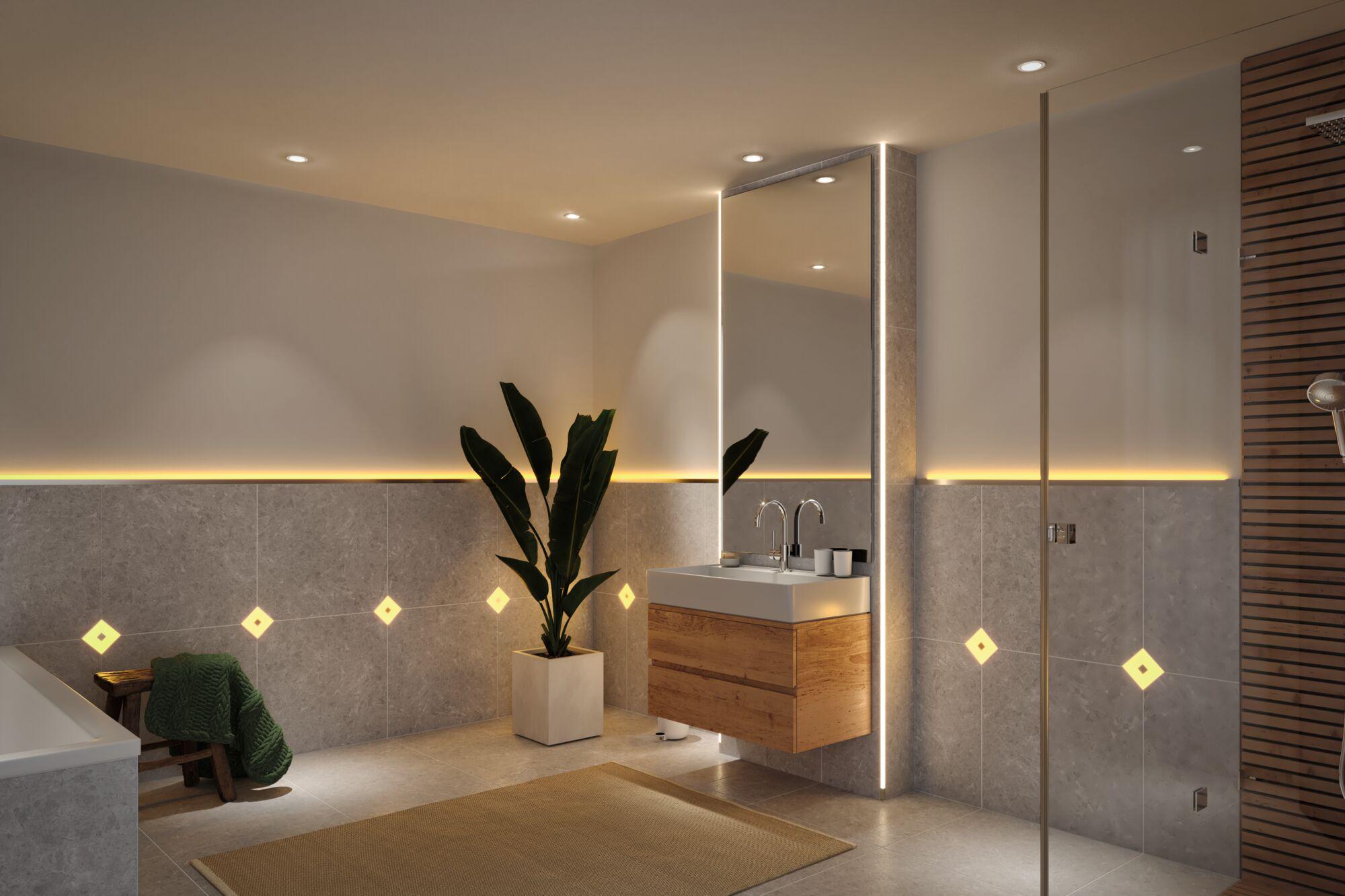 Modern bathroom with grey tiles, wooden vanity unit and warm white LED mirror lighting for ambient light