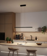 Modern black metal LED pendant light above kitchen island with wooden countertop