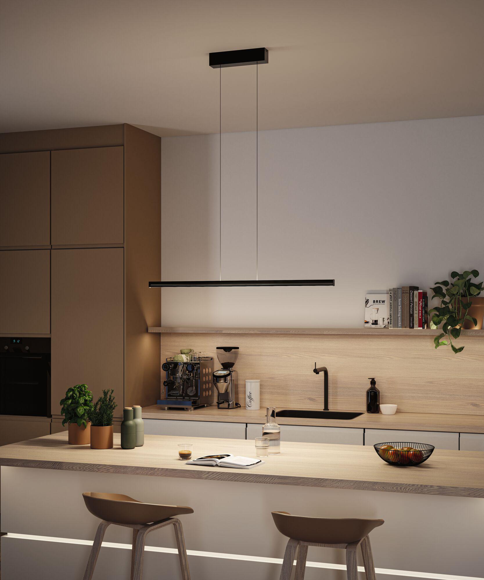 Modern black metal LED pendant light above kitchen island with wooden countertop
