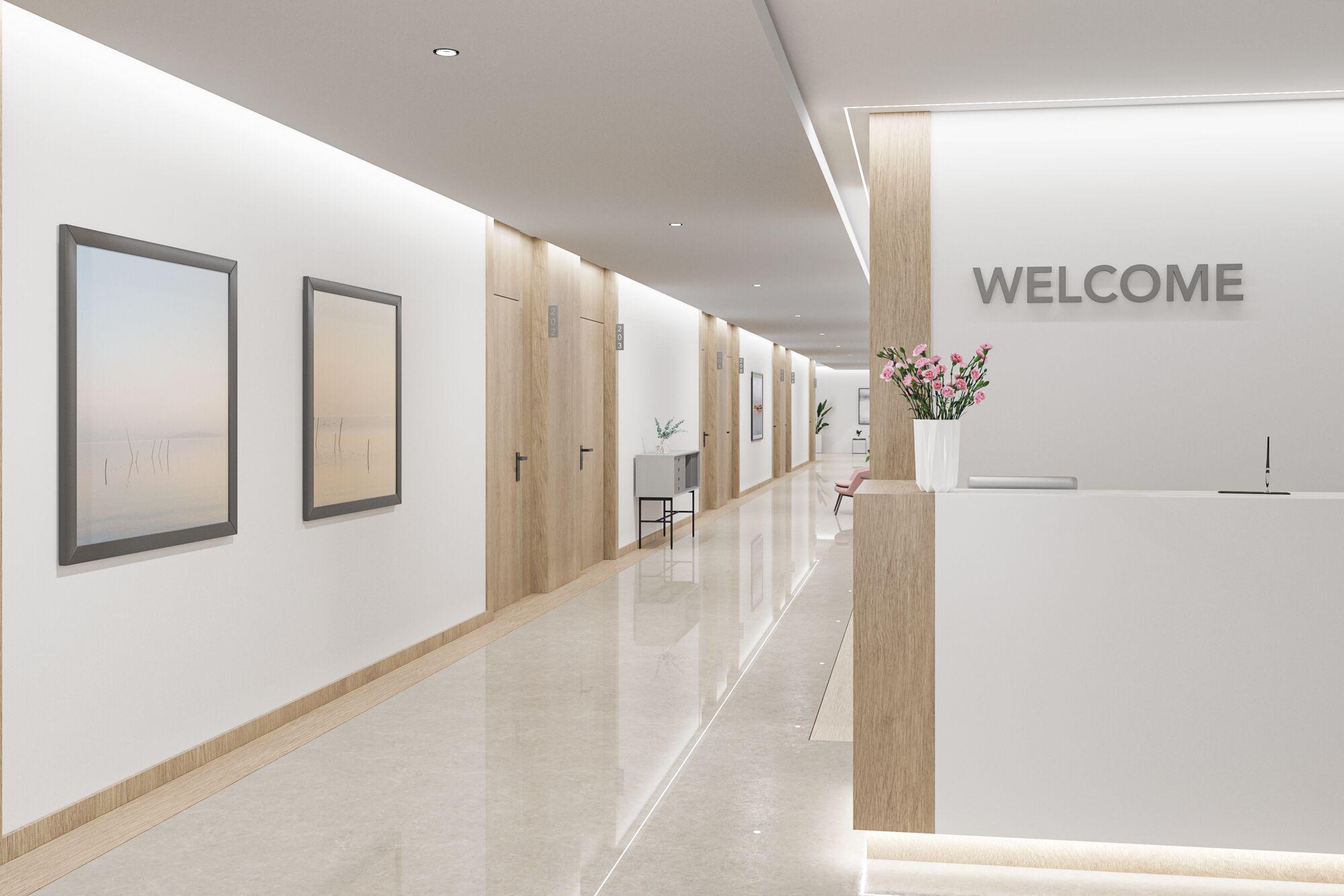 Modern reception area with wood accents, white walls, and LED ceiling lights for office or hotel