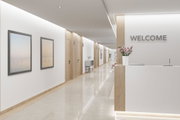 Modern reception area with wood accents, white walls, and LED ceiling lights for office or hotel
