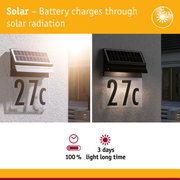 Solar-powered house number light with black casing and LED illumination for energy-saving outdoor lighting