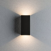 Black aluminium wall light with warm white LED on textured grey wall for modern indoor lighting