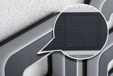 Close-up of grey plastic frame with integrated solar panel for energy-saving lighting solutions