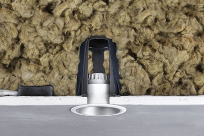 Silver recessed LED spotlight with black bracket and insulation in ceiling cavity for energy-efficient lighting