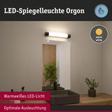 LED-Spiegelleuchte Orgon mit warmweißem Licht über schwarzem Waschbecken und Holzarbeitsplatte im Bad