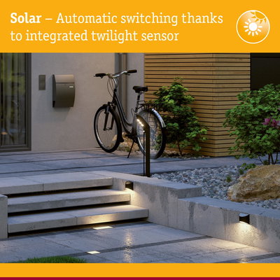 Modern outdoor lighting with integrated twilight sensor illuminating concrete steps and pathway at dusk
