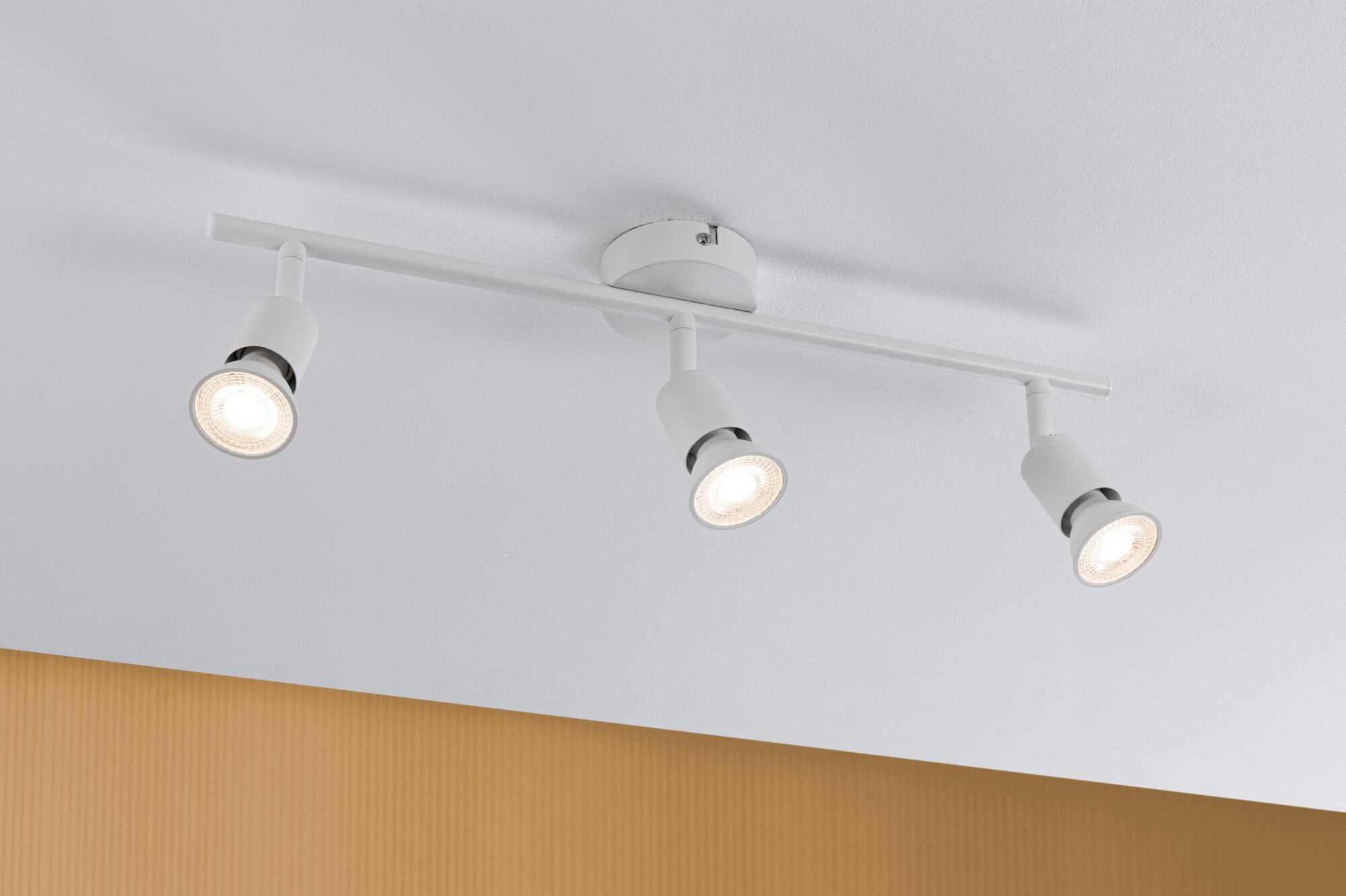 Three white metal LED ceiling spotlights with adjustable heads for modern room lighting