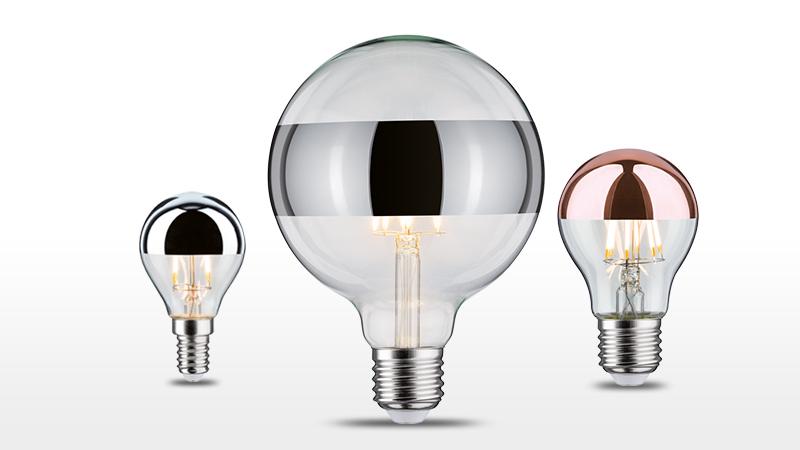 Drie decoratieve LED-lampen met zilveren en koperen spiegelkappen voor modern lichtontwerp.
