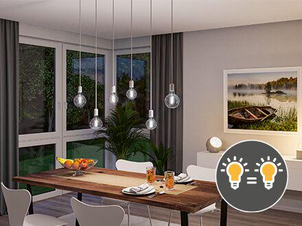 Modern dining area with hanging light bulbs and natural wood table, lighting concept for color consistency.