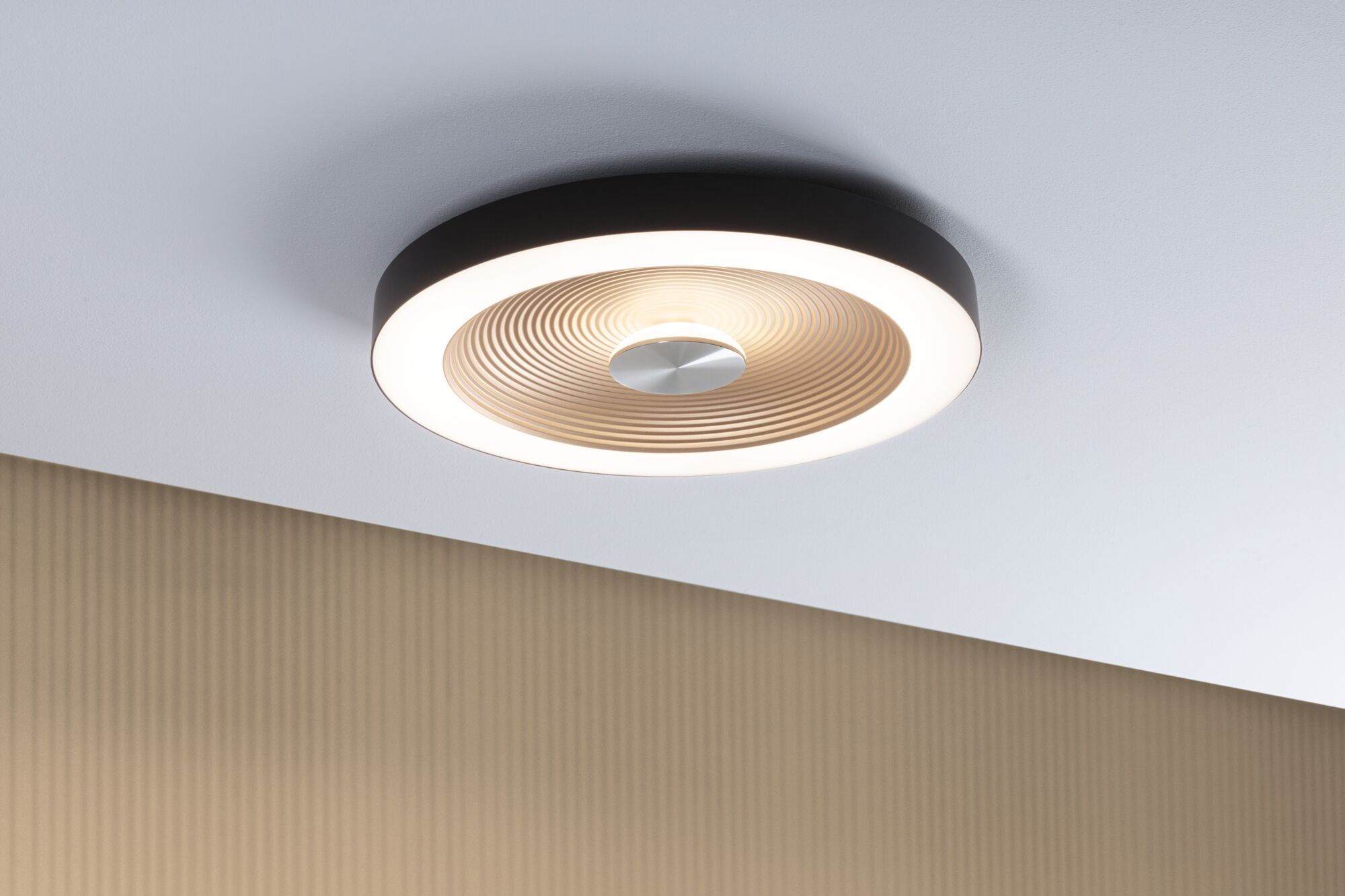 Round ceiling light with black frame and warm white light, modern design for living spaces