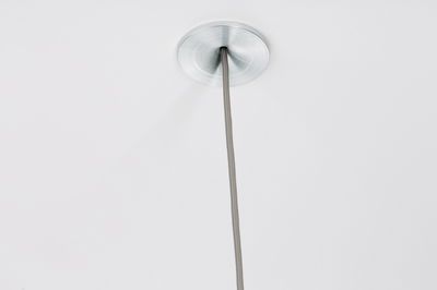 Ceiling with brushed aluminum suspension point and grey textile cable for modern LED lighting.