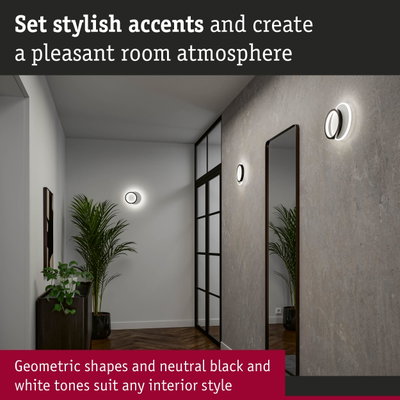 Modern hallway with geometric black and white wall lights and mirror creating stylish room accents