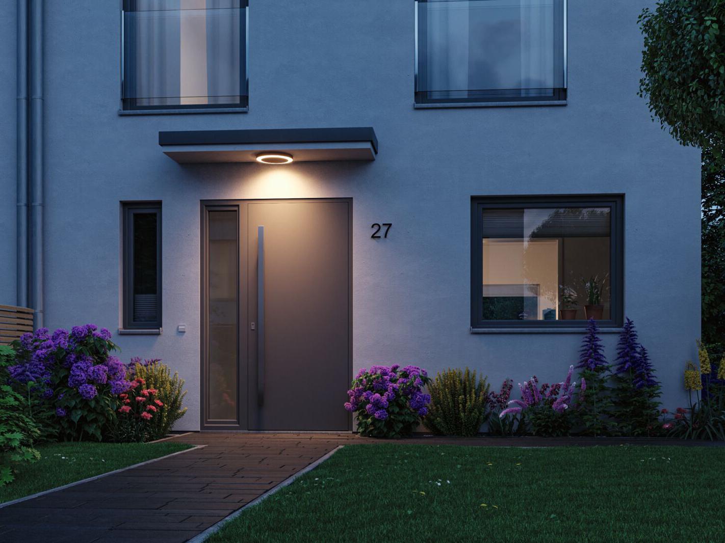 Modern outdoor lighting with warm white LED ring above gray front door and garden path at dusk