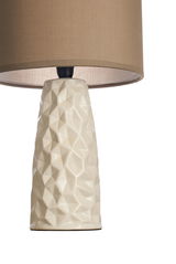Table lamp with cream textured ceramic base and brown fabric shade for living spaces