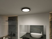 Round ceiling light with black frame in modern bathroom featuring freestanding bathtub.