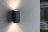Black aluminum wall light with up and down illumination on grey exterior wall for modern outdoor lighting