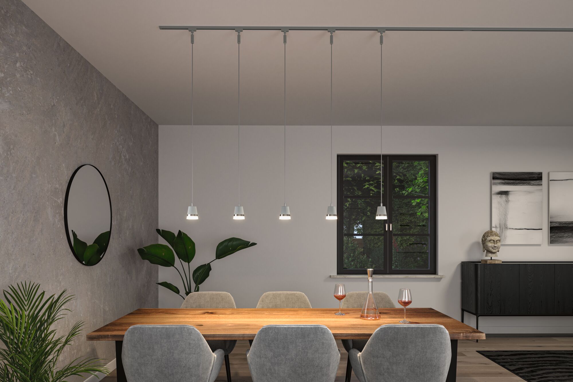 Modern white metal pendant lights above wooden dining table with grey chairs and plants