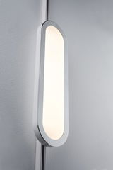 Modern white LED wall light with oval shape and warm white illumination for living spaces