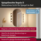 Spiegelleuchte Regula II in Chrom mit warmweißem Licht neben ovalem Badezimmerspiegel