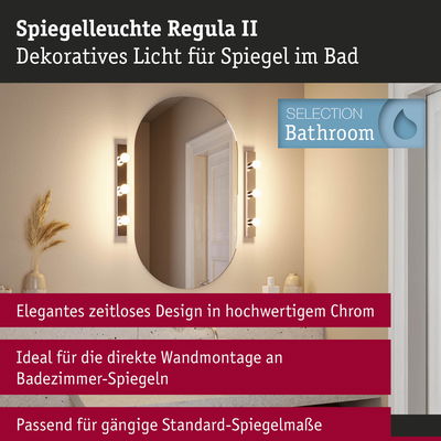 Spiegelleuchte Regula II in Chrom mit warmweißem Licht neben ovalem Badezimmerspiegel