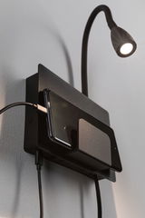 Black wall lamp with flexible arm and metal phone holder, perfect for bedroom lighting and charging station.