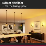 Modern living room lighting with yellow glass pendant lamps and wall lights emitting warm light.