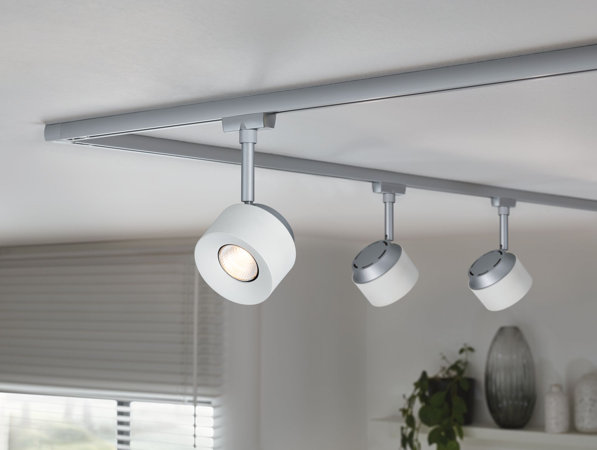 Modern white LED ceiling track with three adjustable metal spotlights for living room lighting