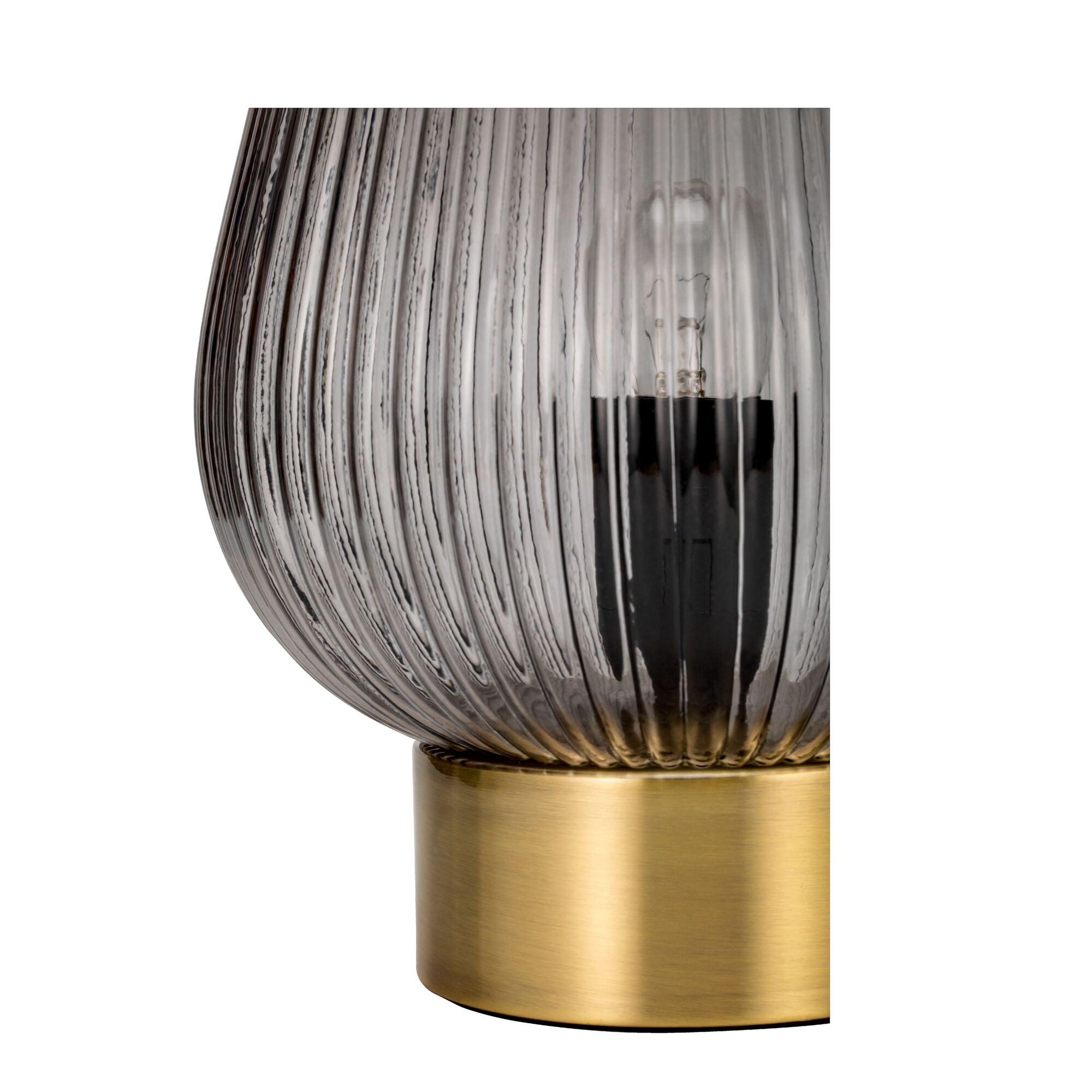 Close-up of table lamp with ribbed smoked glass and gold metal base for stylish home lighting