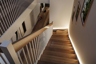 Escalier en bois moderne avec rambarde blanche et éclairage LED indirect sur le mur dans un espace de vie.