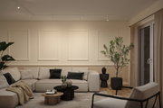 Modern living room with beige corner sofa, black and grey cushions, wooden coffee tables and green plants