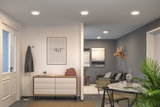 Living room with round white LED ceiling lights, gray walls, and modern dining area with plants.