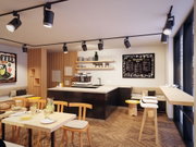 Modernes Café mit schwarzer Deckenstrahler-Beleuchtung und Holztheke in hellem Holz und Schwarz.