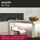 Modern kitchen interior with white counter and LED strip lighting under the countertop for ambient illumination
