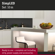 Modern white kitchen island with illuminated counter and transparent bar stool in minimalist style