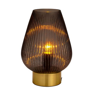 Modern table lamp with ribbed brown glass and gold metal base for ambient lighting in living spaces