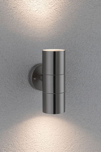Modern stainless steel wall light with cylindrical shape and up-down lighting for outdoor use.