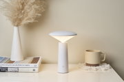 Modern white metal LED table lamp with dome-shaped diffuser for ambient lighting in living spaces